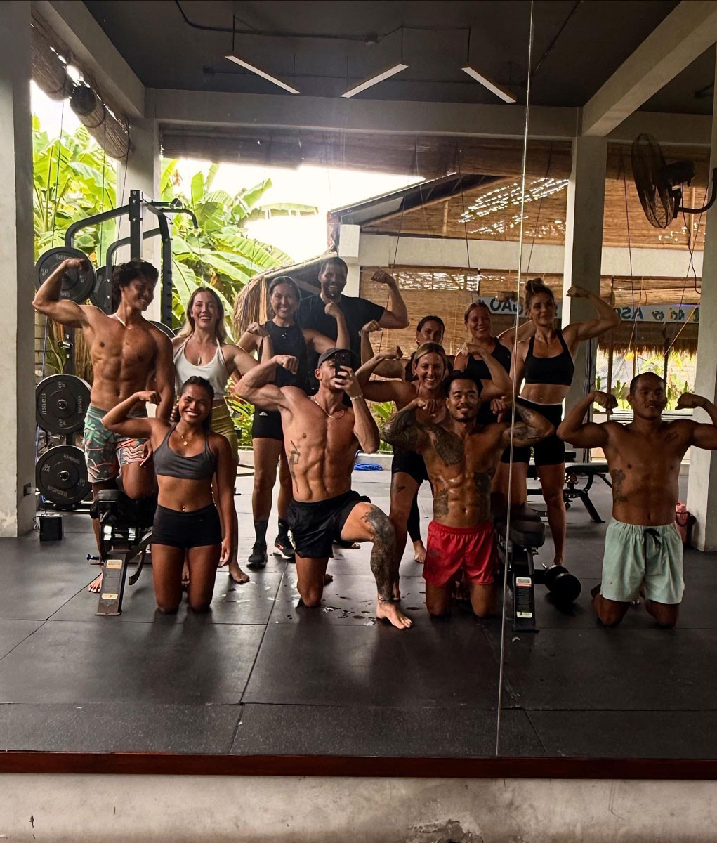 The coach is taking a photo with others.